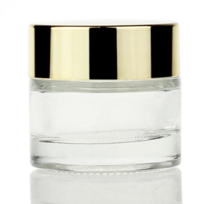 クリームのための卸し売り試供品Oemの贅沢な金カバー明確なガラス化粧品のクリーム色の瓶10g